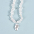Irregular white crystal stone bead necklace featuring a baroque pearl pendant over blue - Clear Quartz Pearl