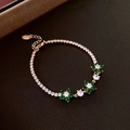 Gold plated tennis bracelet featuring green emerald-like flowers and cubic zirconia - Green Flower Square Zirconia Bracelet