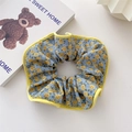 Blue floral scrunchie hair tie with yellow piping detail and a high-elasticity fabric - Gray Background Yellow Flower