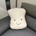 Soft plush toast pillow with cute smiley face embroidery on a leather sofa - Toast Bread Pillow / 48*40*15cm