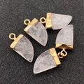 Detailed macro view of five pointed tooth-shaped crystal pendants with gold metal bails - White Crystal