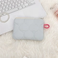 Close-up of a light blue quilted cosmetic bag with cloud pattern on soft plush fabric - Light Blue