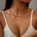 Golden necklace with vibrant colorful heart-shaped gemstones worn by a fashion model - Necklace / Gold Multi-color