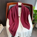 Detail of a burgundy solid linen scarf draped over a white shirt for a layered look - Fuschia