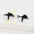 Detail view of 1.5cm black heart rate ECG stud earrings on textured stone base - Heart Beat / Black
