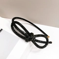 Detail of black rhinestone headband with double bow design and golden metal tips - Knotted Full Black Rhinestone Slim Headband