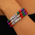 Close-up of three colorful beaded bracelets with LOVE, LAUGH, and SMILE letter charms - Colorful Letters (8568)