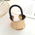 Polished gold metal ponytail cuff with black elastic hair tie on a white background - Crescent Moon / Rose Gold