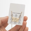 Golden double-layered necklace featuring 555 angel numbers pendant on display card - Cutout 555 / Gold