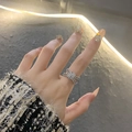 Chic silver knot ring with pavé rhinestones worn by a model in a luxury setting - Micro-set Diamond Knot Ring