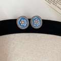 Macro shot of vintage round blue enamel earrings with pearls and gold floral trim - Gold-Blue-Pearl Flower
