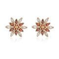 Macro shot of gold-plated flower stud earrings with red and clear zircon stones - Red