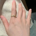 S925 sterling silver gold ring with pearls and floral shell design on a model's finger - Shell Gemstone