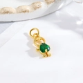 Detailed view of a gold-tone girl pendant with an inlaid green faceted gemstone charm - Little Boy - Green Heart