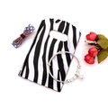 Silver bangle bracelet with metallic charm pendants on a patterned gift packaging bag - No. 15 (Zebra Texture)