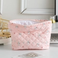 Pink quilted makeup bag with cute rabbit and floral patterns on a bright tabletop - Pink Bunny