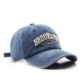 Close-up of beige Brooklyn 1947 3D embroidery on a washed blue vintage baseball cap - Adjustable / Navy Blue