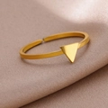 Macro shot of gold-plated open ring with a minimalist triangle geometric design - Gold Triangle