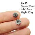 Close-up of 7.5mm vintage silver flower spacers on a fingertip showing fine leaf textures - 10#