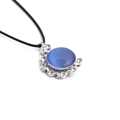 Detail of round blue cat eye stone pendant with silver moon and star crystal accents - Blue/Black Rope