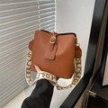 Brown lychee leather bucket bag with wide jacquard shoulder strap and gold hardware - Brown