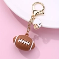 Detail view of brown rubber football keychain with white metal helmet on golden chain - Rugby Style (068 Rugby)