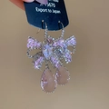 Detailed close-up of bowknot zircon earrings with pink water drop crystal tassels - Pink Ear Hooks