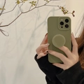 Detail of army green silicone iPhone case set with matching circular pop socket stand - 15 Pro Max / Rock Green