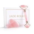 Detail of rose quartz face roller and heart scraper set with gold metal accents - Rose Quartz Gift Box Set