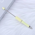 DIY beaded ballpoint pen in pale yellow with metal rod on a plush white background - Milky Yellow