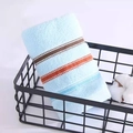 Light blue cotton towel with striped patterns in a black metal basket for home decor - Weak Twist Dotted Satin Blue / 34*74cm