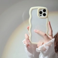 White wavy edge phone case for iPhone shown with stylish hand-held pose and rainbow lighting - iPhone 14 Pro Max / Yellow