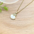 Elegant gold necklace with white shell pendant and diamond-encrusted starfish detail - Shell Starfish Pendant