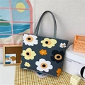 Women's dark grey canvas tote bag featuring large yellow and white floral print with handles - Sunflower