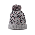 Close-up of knit beanie with pink leopard print pattern and colorful pom-pom top - Pink Leopard