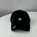 Detail of embroidered letters on a black baseball cap with curved brim and cotton texture - One Size (54-60cm) / Black