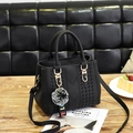 Black pebbled leather tote bag with V-quilting, gold hardware and plush pom-pom charm - Black
