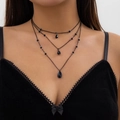 Detail of triple-layer gothic necklace with black crystal teardrop pendants on a model - 05 Black Three-Layer Layered Necklace