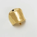 Close-up of a minimalist gold hair clip with a smooth metallic irregular curved surface - Bright Gold