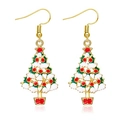 Detailed macro view of golden Christmas tree earrings with colorful enamel decorations - Black Polka Dot