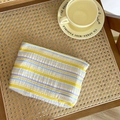 Candy colored bubble fabric makeup bag featuring yellow, blue, and white stripes - Pleated Stripe Storage Bag - Yellow