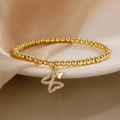 Elegant gold butterfly bead bracelet with white zircon charms on white ceramic plate - Double Butterfly Style
