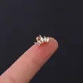 Golden fan-shaped ear stud with aurora marquise-cut zircons held on a fingertip - Fan Arc Aurora Gemstone Style (HSPJ308-11#G)