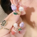 Elegant purple tulip pearl earrings with gold leaf accents on a warm skin tone background - Taro Purple