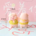 Detailed view of mini pink resin pig figurines with height 2.5cm and width 1.8cm - Swimsuit Pig