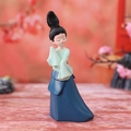 Classical Chinese lady figurine with green top and blue skirt on pink background - Medium Lady (Raising Hand)