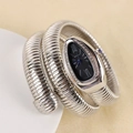 Silver snake-shaped wrap watch with black dial and crystal bezel on a textured surface - Black Dial / Silver