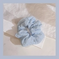 Light blue fuzzy scrunchie with soft pleated texture on a white decorative paper background - 1043H Light Blue Puff Chiffon Seersucker