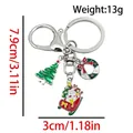 Silver metal Christmas keychain featuring enamel snowman, green tree and festive wreath - ER1789-Ski Sled Santa Tree 8-shape Keychain