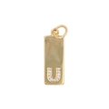 Detailed view of a gold rectangular letter U pendant with sparkling cubic zirconia stones - Letter U